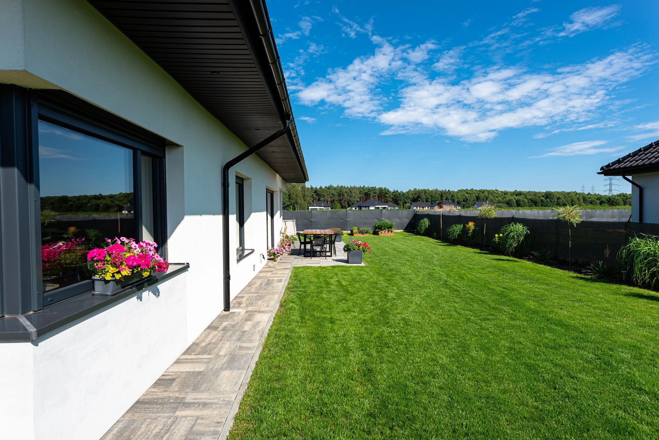 Clean home exterior with lawn and patio