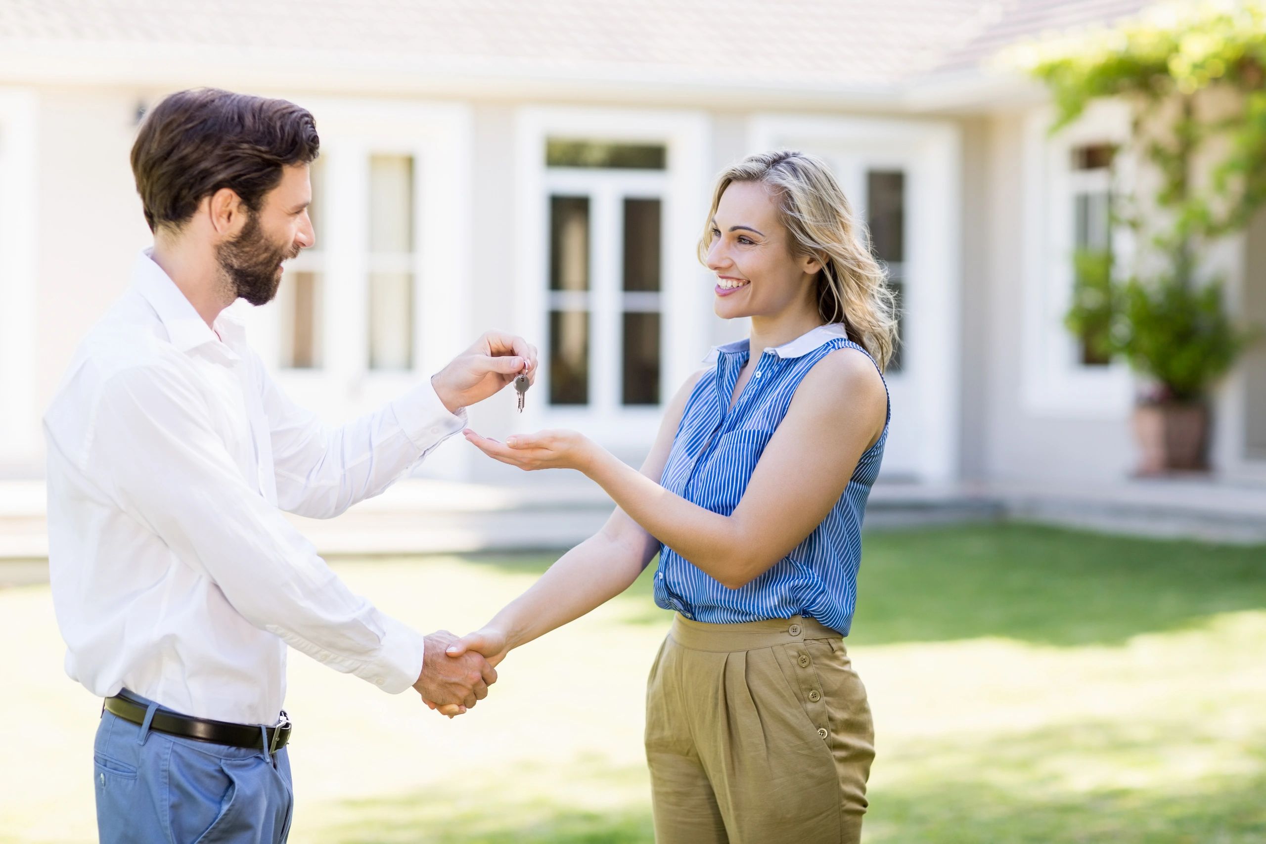 Professional handing keys to a homeowner
